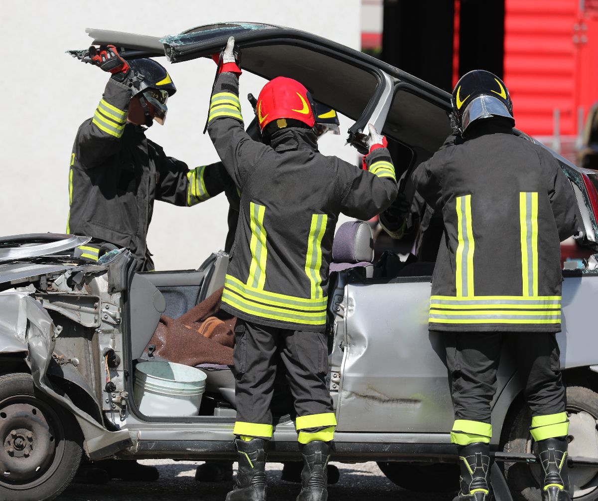 firefighters open a damaged car after the road traffic accident