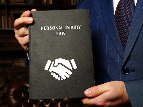 personal injury lawyer with law manual